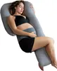 A pregnant woman is sleeping on her side, using a large U-shaped pillow for support. Produktbild-Vorschau