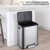 A stainless steel dual-compartment trash can with its lid open, placed in a modern kitchen setting. Podgląd zdjęcia produktu