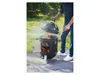 A person is using a smoker grill outdoors. Produktbild-Vorschau