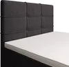 A close-up view of a bed with a dark gray upholstered headboard and a white mattress. Produktbild-Vorschau