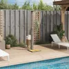 An outdoor shower next to a swimming pool on a wooden deck. Náhľad obrázku produktu