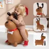 A toddler is happily playing on a brown inflatable dog toy. The image is a collage with additional shots of the toy. Voir les images du produit