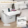 A white nightstand with various storage features is shown next to a bed. Podgląd zdjęcia produktu