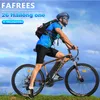 A man is riding an electric mountain bike outdoors on a grassy hill with a blue sky and clouds in the background. Produktbild-Vorschau