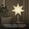 A star-shaped lamp is placed on a side table next to a sofa, creating a cozy atmosphere. Podgląd zdjęcia produktu