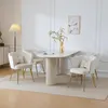 A dining set with four chairs and a table in a well-lit room.
