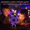 Two young children looking at a glowing soccer ball lamp. Produktbild-Vorschau