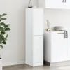 A white apothecary cabinet is shown in a room with a plant and kitchen cabinets in the background. Produktbild-Vorschau