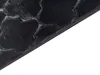 A close-up view of a dark-colored rug with a textured pattern. Náhled obrázku produktu