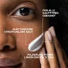 Close-up of a person's face with cream being applied, with text overlays highlighting product benefits. Podgląd zdjęcia produktu