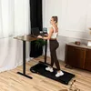 A woman is working on a laptop while standing on a treadmill next to a standing desk in a home office setting. Náhľad obrázku produktu