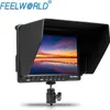 A camera field monitor with a sun hood attached, displaying a sunset scene on its screen, mounted on a small tripod adapter. Náhled obrázku produktu