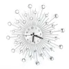 A decorative wall clock with a sunburst design and crystal accents, presented against a white background. Podgląd zdjęcia produktu