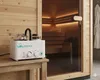A white SalzMax device is placed on a wooden shelf in front of a sauna. Produktbild-Vorschau
