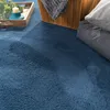 A close-up view of a textured blue rug. Produktbild-Vorschau