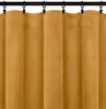 A close-up view of a mustard yellow curtain hanging from a black curtain rod. Náhled obrázku produktu
