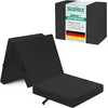 A folded black mattress is shown in front of its packaging. Produktbild-Vorschau