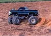A remote-controlled monster truck driving on a dirt track. Produktbild-Vorschau