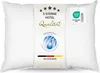A white pillow with a label attached, featuring product information and certifications. Produktbild-Vorschau