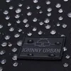 A close-up of a black fabric surface with water droplets and a black label with the brand name 'JOHNNY URBAN' and a logo. Anteprima dell’immagine prodotto