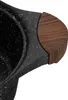 A close-up view of the handle of a black speckled pot with a wooden accent. Produktbild-Vorschau