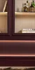 A close-up view of a cabinet with shelves displaying books and bottles, with integrated lighting. Náhľad obrázku produktu