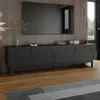 A modern living room with a black TV stand and a large television mounted on a wood-paneled wall. Náhľad obrázku produktu