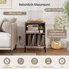 A record player stand with vinyl records and a radio, next to a couch and a guitar. Text overlays describe the storage space and features. Voir les images du produit