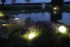 A garden pond at dusk, illuminated by spherical garden lights. Produktbild-Vorschau
