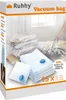 A stack of vacuum seal bags with clothes being vacuumed out of one bag on a bed. Náhľad obrázku produktu