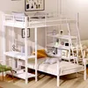 A white metal bunk bed with a desk and shelves, set up in a room. Produktbild-Vorschau