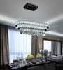 A crystal chandelier hangs above a dining table set for a meal. Anteprima dell’immagine prodotto