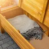 A wooden garden bench with its storage compartment open, revealing a folded blanket inside. Náhled obrázku produktu