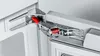 A close-up view of a refrigerator hinge mechanism. Produktbild-Vorschau