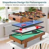 A stacked multi-game table with foosball, ping pong, air hockey, and billiards on display in a room with a window and radiator. Produktbild-Vorschau