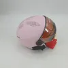A pink helmet with a brown visor is shown against a white background. Anteprima dell’immagine prodotto