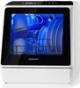 A white countertop dishwasher with a glass door, showing dishes inside illuminated by blue light. Produktbild-Vorschau