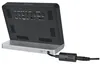 The back of a black and silver digital clock with a power adapter plugged in. Produktbild-Vorschau