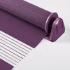 A close-up view of a purple roller blind with alternating opaque and sheer stripes, showing the mechanism at the top. Produktbild-Vorschau