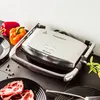 A grill and ingredients on a countertop. Produktbild-Vorschau