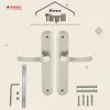 A product image showcasing a pair of silver door handles and their accessories against a light beige background with decorative elements. Produktbild-Vorschau
