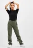 A woman is posing in a studio setting, wearing the product. Produktbild-Vorschau