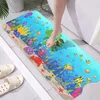 A person's foot stepping onto a colorful bath mat with an underwater theme, placed next to a bathtub. Produktbild-Vorschau