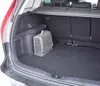 The interior of a car trunk with a folded fabric storage bag placed on the floor. Anteprima dell’immagine prodotto