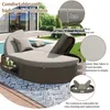 A round rattan daybed with cushions is shown outdoors by a swimming pool. Produktbild-Vorschau