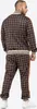 A man wearing a brown plaid tracksuit. Anteprima dell’immagine prodotto