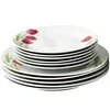 A stack of white porcelain plates with a floral design. Náhľad obrázku produktu