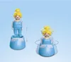 Two images of a Cinderella toy figure, one showing it standing and the other showing it spinning. Produktbild-Vorschau