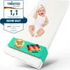 A baby is lying on a white mattress with various certifications and logos around it. Produktbild-Vorschau