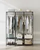 A clothing rack with clothes hanging on it and storage bins on the shelves. Náhled obrázku produktu
